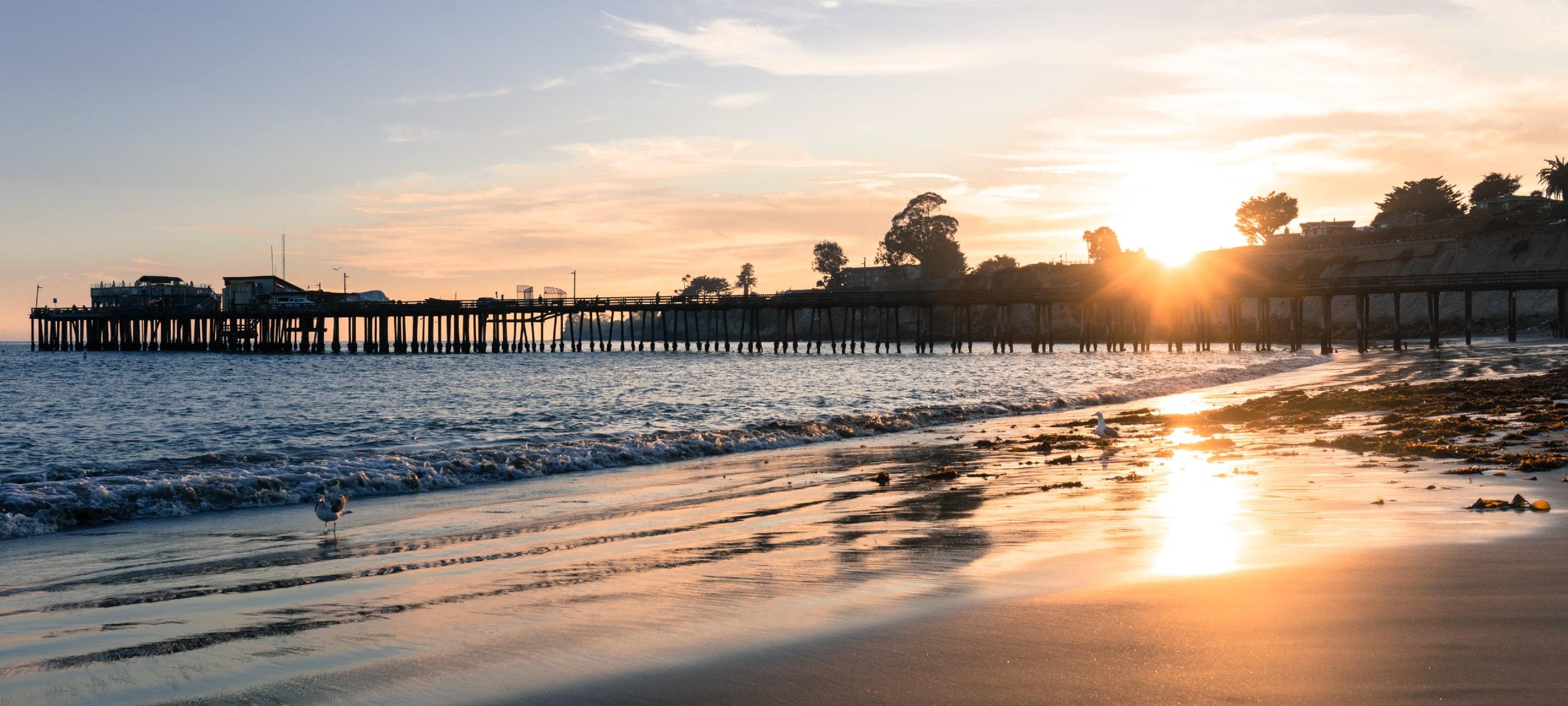 Sunset on beach at Capitola Wharf in California