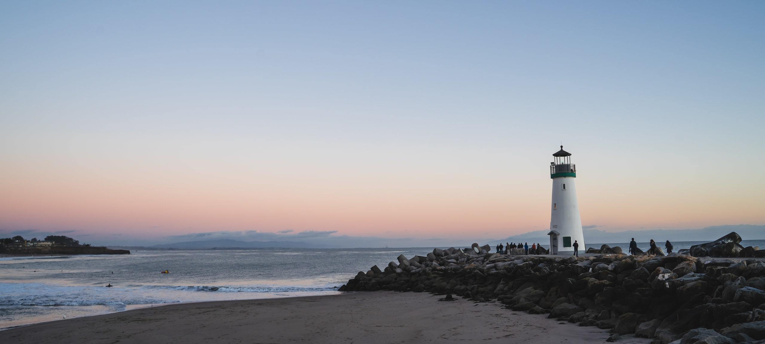 Sunrise on waterfront with lighthouse in Santa Cruz, CA