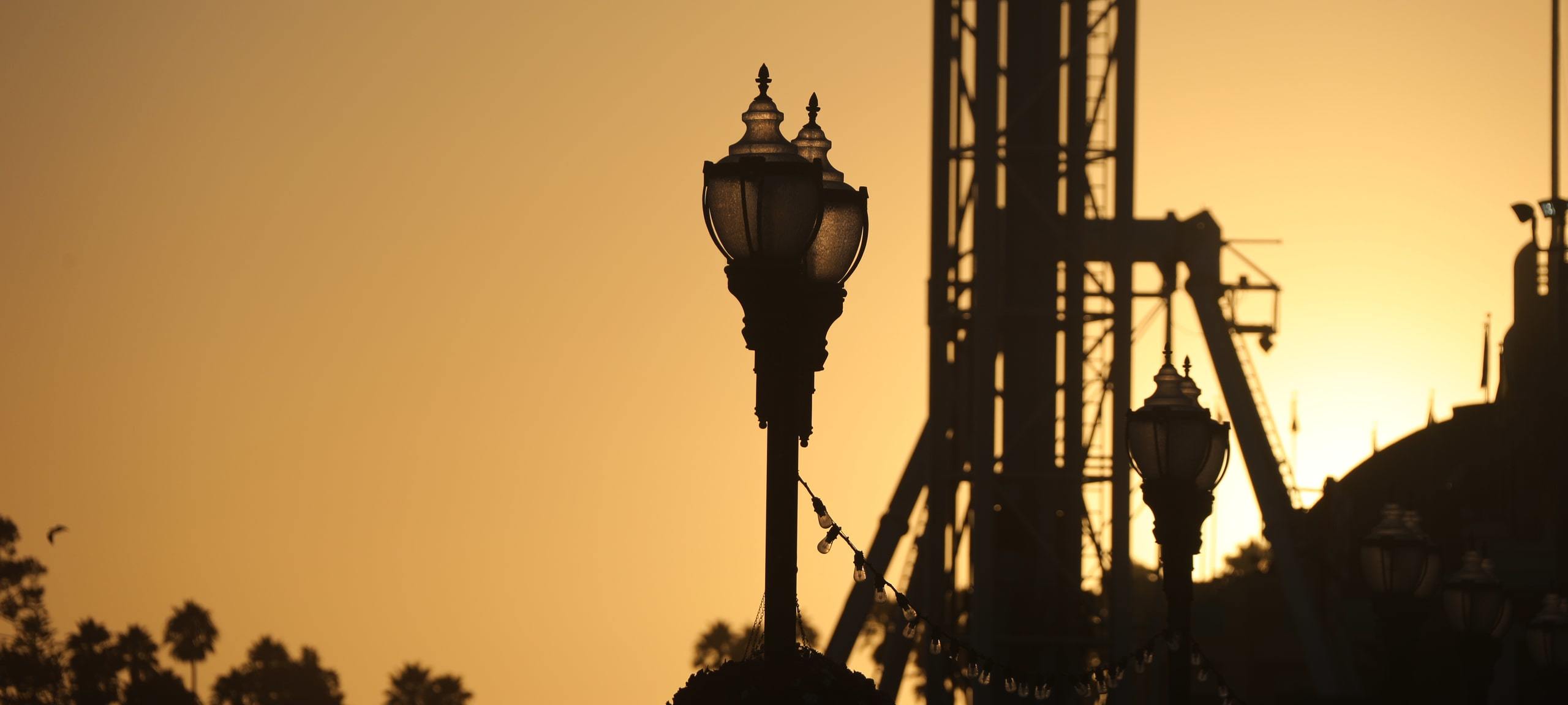 Silhouette of street lamps and amusement park rides during sunset, Santa Cruz County Fair