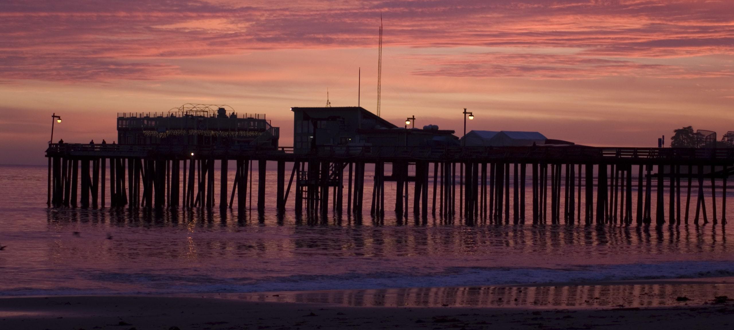 Pink sunset and silhouette of Capitola, CA pier