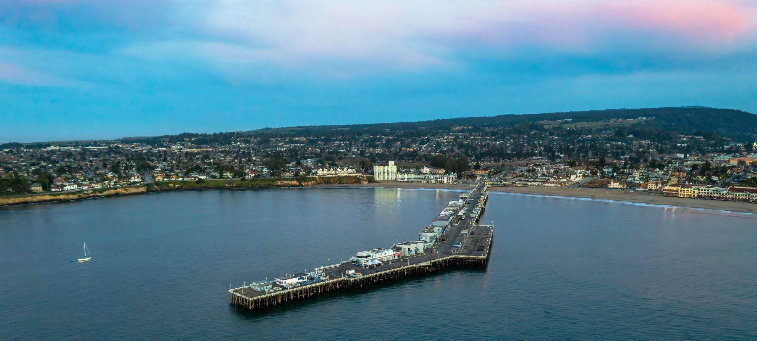 View over Santa Cruz Wharf and waterfront with blue and pink clouds