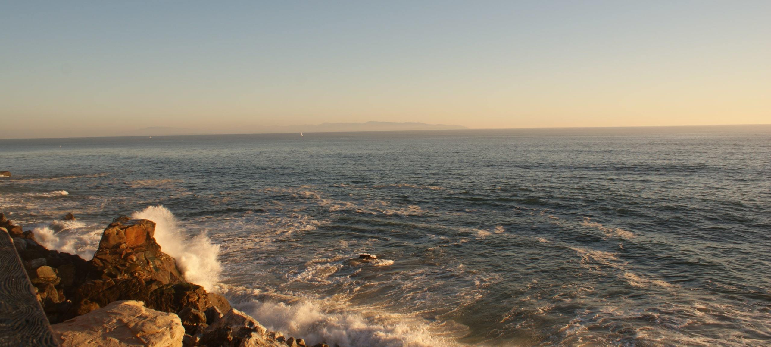 Crashing waves at Santa Cruz waterfront during sunset