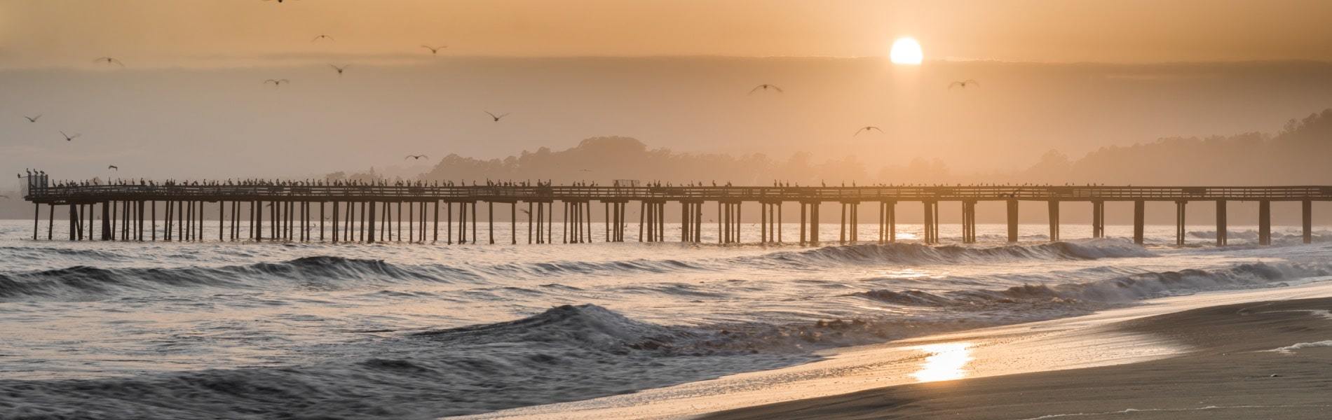 View of waves and pier in Seacliff, CA