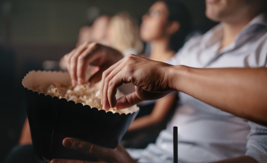 People eating popcorn in their theater seats