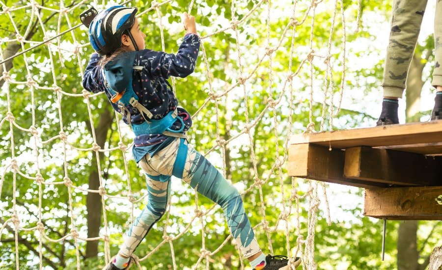 Young girl in adventure ropes course