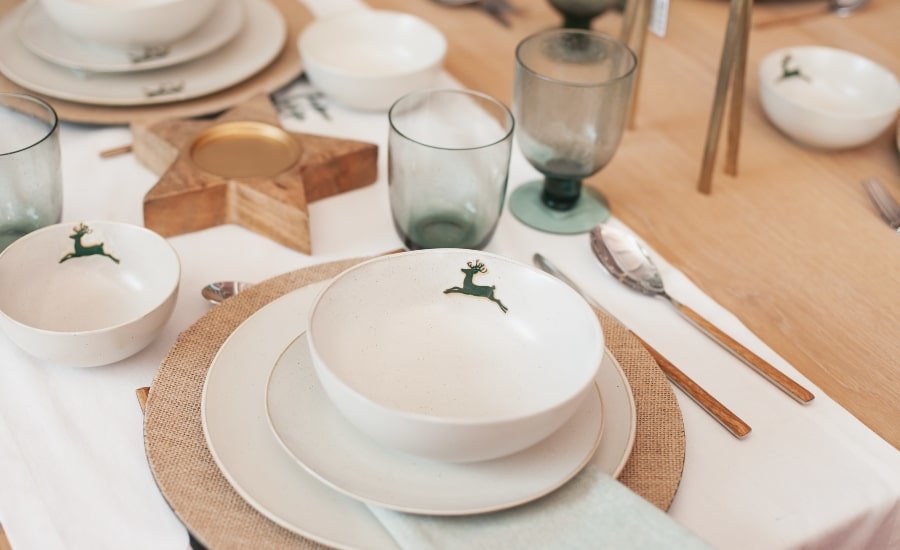 Modern table setting during holidays with plates and center piece
