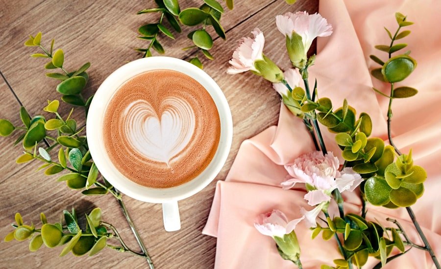 Coffee with heart foam and flowers
